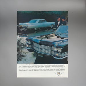 May include: Vintage advertisement featuring two classic Cadillac cars, one light blue and the other dark blue. The cars are parked near water, with reflections visible. The text reads, "WHICH GENTLEMAN JUST JOINED THE CADILLAC FAMILY?"