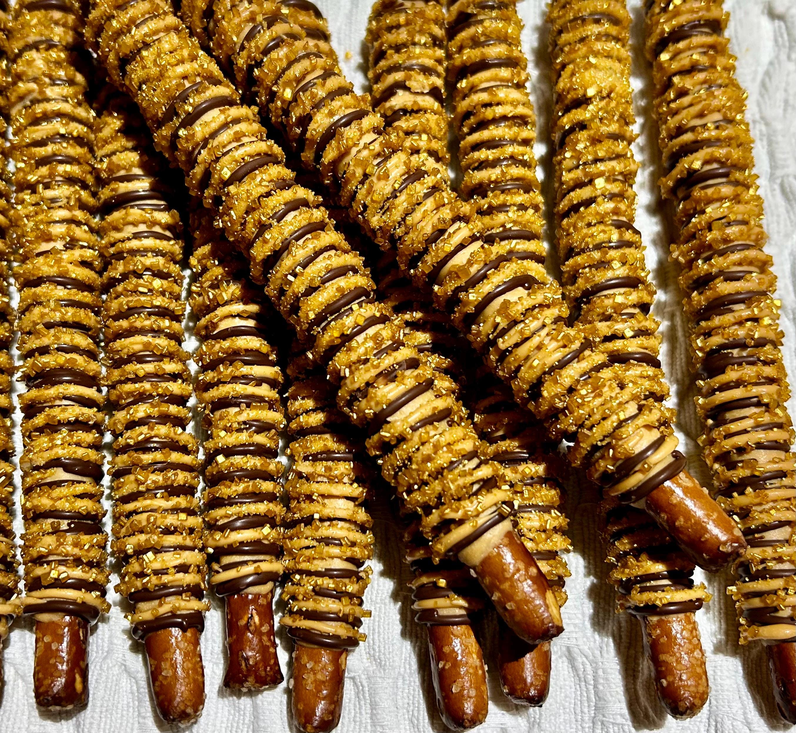 Image showcasing Caramel Coated Pretzel Rods With Chocolate Drizzle & Golden Sugar ...