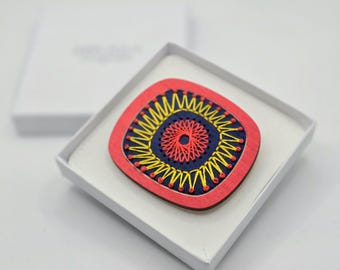 Broche de madera contrachapada de abedul, pintado y bordado a mano, inspirado en el 'Sputnik' de los años 60.