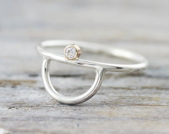 Half moon engagement ring in sterling silver and gold with tiny diamond