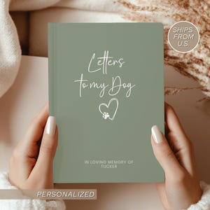 May include: Sage green journal with the text "Letters to my Dog" in a handwritten font. A heart with a paw print is below the text. The words "In loving memory of Tucker" are at the bottom.