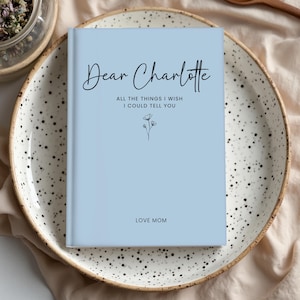 Loss of Daughter Grief Journal personalized with name and message on a neutral beige cover featuring delicate flower sketch. A heartfelt sympathy gift and memory journal for grieving mother, perfect for writing letters to a daughter in heaven.