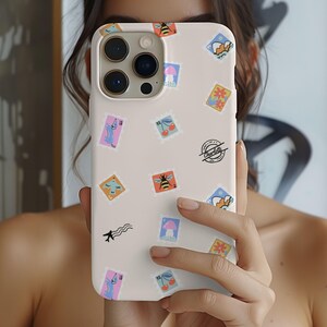 May include: A white iPhone case with a colourful pattern of stamps featuring bees, cherries, flowers, and aeroplanes. The case has a black "Thank You" stamp on the bottom right corner.
