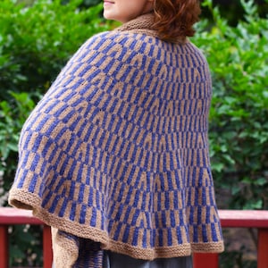 May include: A blue and tan knitted cape with a geometric pattern. The cape has a high collar and a wide, flowing shape. The color scheme is a combination of blue and tan, creating a visually appealing design. The cape is made of a soft, textured yarn.