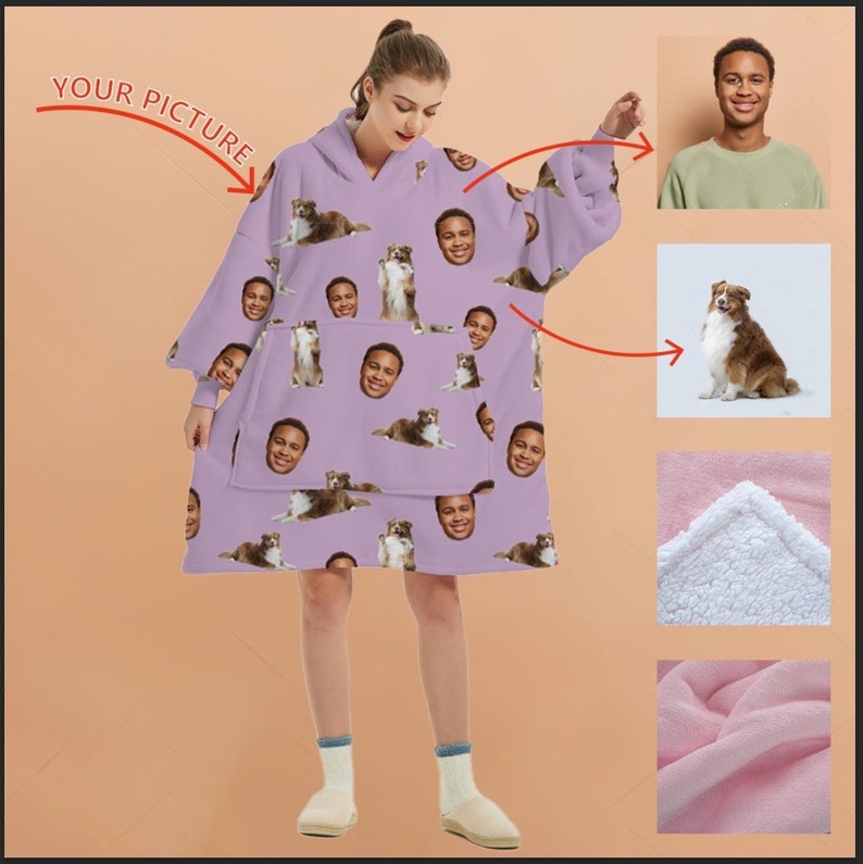 May include: A purple hooded blanket with a repeating pattern of a person's face and a dog. The blanket has a large pocket in the front and is made of soft fleece.