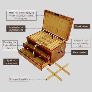 May include: A wooden jewelry box with a velvet interior and multiple compartments. It features metal hooks for necklaces, a velvet pocket, and drawers. The box has metal handles and a key to lock all three layers. A removable divider is included.