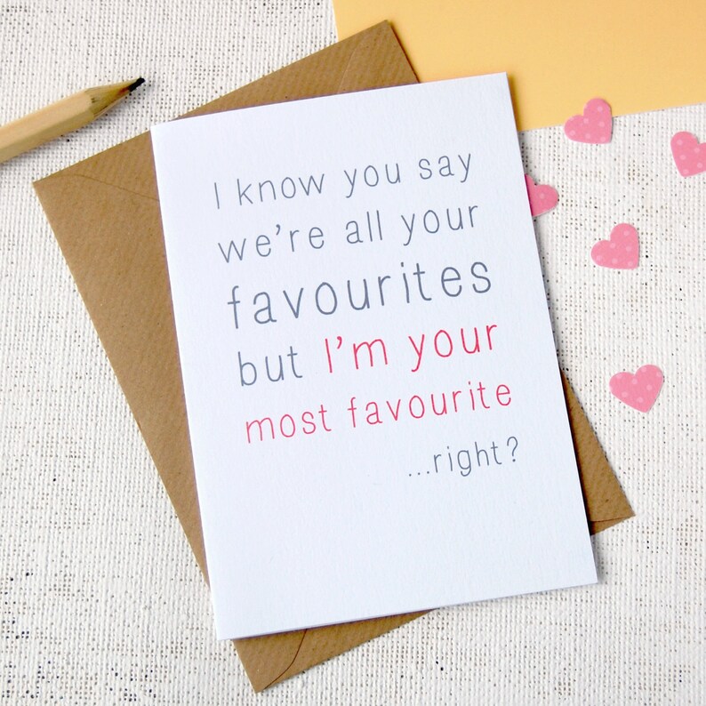 White background, with craft envelope and white A6 greeting card reading i know you say we are all your favourites but im your most favourite...right? Writing is in grey except for im your most favourite which is in a rose pink