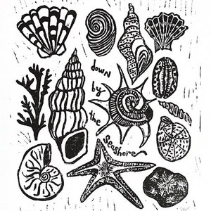 May include: Black and white linocut print of seashells, seaweed, a starfish, and the text "down by the seashore".