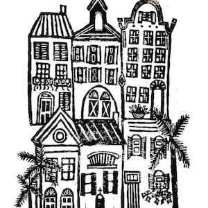 May include: Black and white linocut print of a row of houses with a palm tree on each side. The houses have multiple windows and doors, and the roofs are detailed with lines and patterns.