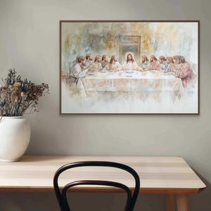 May include: A watercolor painting depicting the Last Supper, featuring Jesus Christ and his disciples gathered around a table. The painting is framed in a brown wood frame and hangs on a light gray wall.