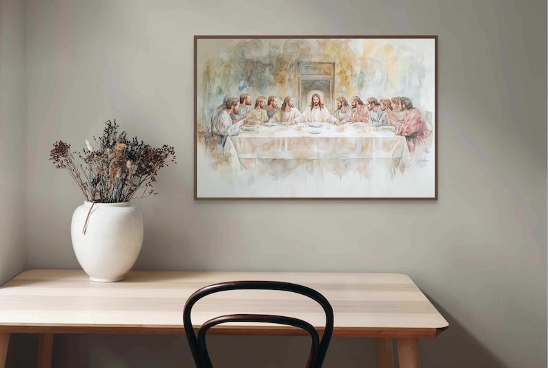 May include: A watercolor painting depicting the Last Supper, featuring Jesus Christ and his disciples gathered around a table. The painting is framed in a brown wood frame and hangs on a light gray wall.