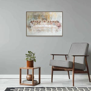 May include: A watercolor painting depicting the Last Supper, featuring Jesus and his disciples gathered around a table. The painting is framed in a simple wooden frame and hangs on a light gray wall.