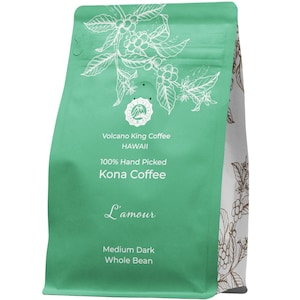 May include: A green bag of Volcano King Coffee from Hawaii. The bag features a white illustration of a coffee plant and the text "100% Hand Picked Kona Coffee L'amour Medium Dark Whole Bean".