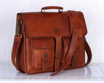 Pasta executiva marrom em couro com alça de ombro e compartimento acolchoado para laptop.