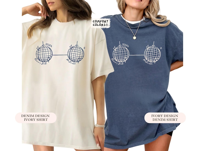 May include: Two t-shirts, one cream and one denim blue, each with a graphic of two disco balls linked by a line. The text "Olivia's Bach" and "Nashville" are below the disco balls. The cream shirt has "Denim Design Ivory Shirt" text.