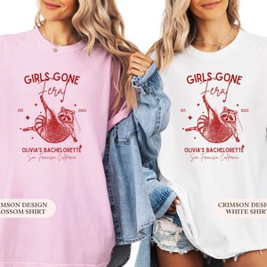 May include: Two t-shirts, one pink and one white, featuring a red raccoon graphic and the text "GIRLS GONE FERAL" and "OLIVIA'S BACHELORETTE San Francisco California". The pink shirt is labeled "BLOSSOM SHIRT".