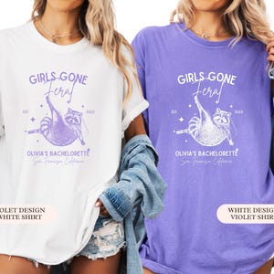 May include: White and violet t-shirts featuring a raccoon graphic and the text "GIRLS GONE FERAL" and "OLIVIA'S BACHELORETTE San Francisco California". The shirts are part of a bachelorette party theme.