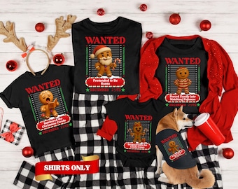Puede incluir: Una colección de camisetas negras y un body de bebé con gráficos de personajes de pan de jengibre, el texto WANTED, North Pole Correctional y December 25th. Cada prenda muestra un personaje único con una descripción de un crimen navideño.