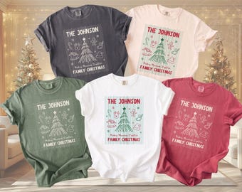 May include: Five short-sleeved crew neck t-shirts in charcoal, light pink, olive green, white, and dark red. Each shirt features a graphic print with the text THE JOHNSON, FAMILY CHRISTMAS, and MAKING MEMORIES TOGETHER, alongside a Christmas tree.