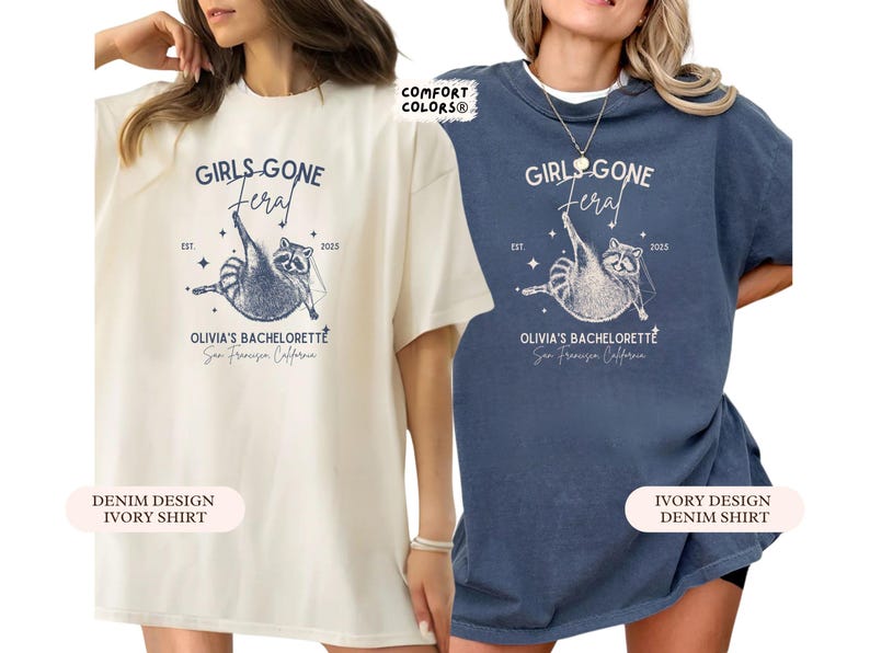 May include: Two t-shirts, one cream and one denim blue, with a raccoon graphic and the words "GIRLS GONE FERAL", "OLIVIA'S BACHELORETTE" and "San Francisco California". The shirts have a loose fit and are suitable for casual wear.