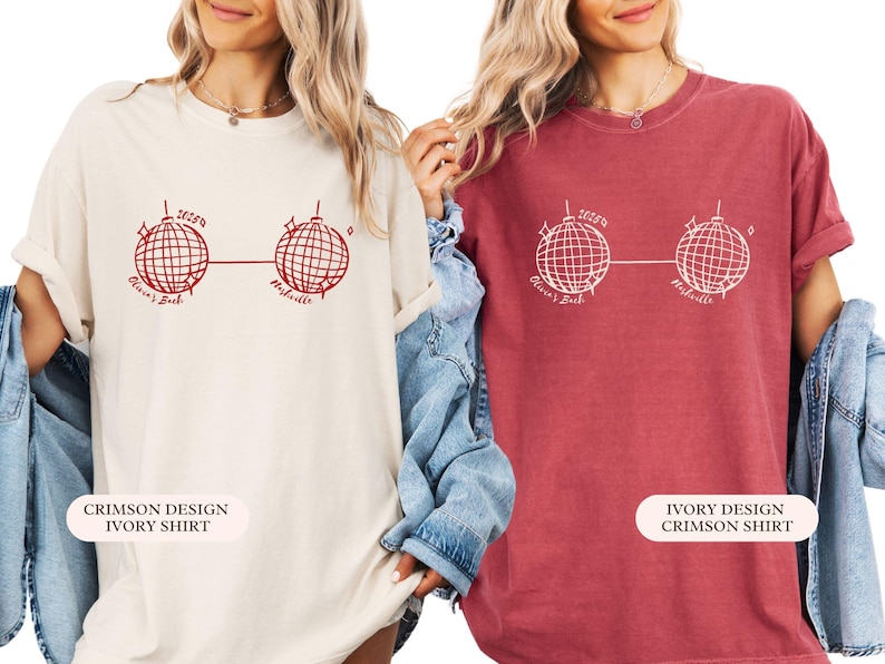 May include: Two t-shirts, one cream and one crimson, each with a red graphic of two disco balls linked by a line. The text above the left disco ball reads "2023", and below the disco balls are the words "Olivia's Bash" and "Nashville".