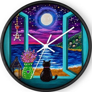 May include: A round wall clock with a black frame featuring a painted scene of a black cat sitting on a windowsill looking out at a moonlit ocean. The scene includes a green vase with pink flowers, a lantern, and a hanging star ornament.