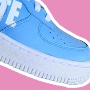 May include: Close-up of a light blue sneaker with a white sole and white "OFF" text on the side.