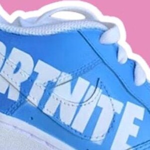 May include: A pair of blue and white sneakers with the word "FORTNITE" printed on the side.