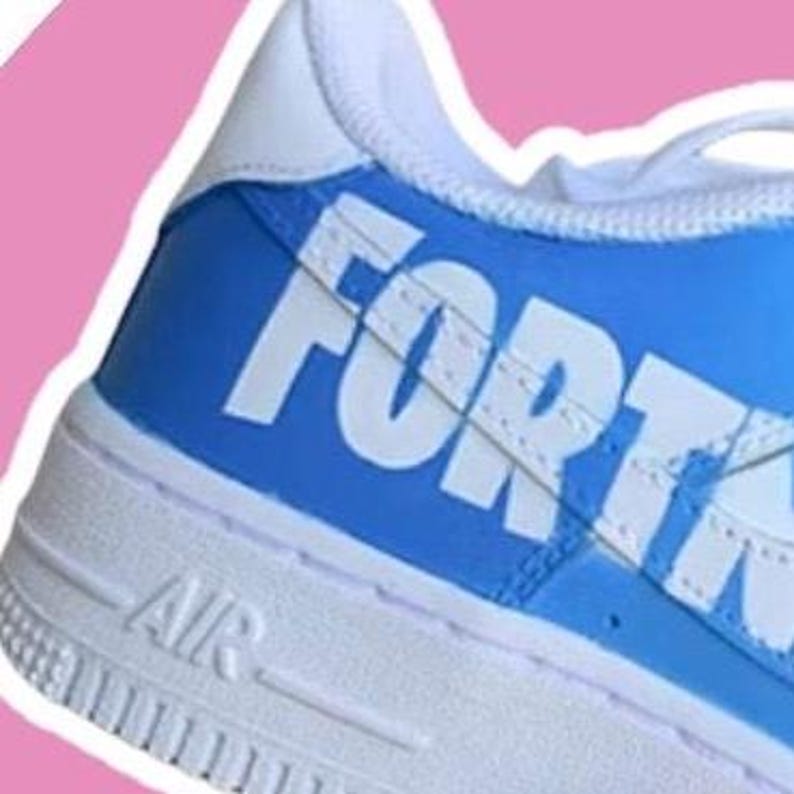 May include: White and light blue sneakers with the word "FORTNITE" printed in white on the side.