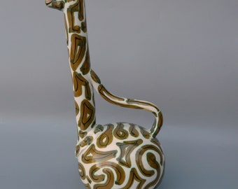May include: A ceramic giraffe-shaped vase with a white background and brown and green abstract patterns.
