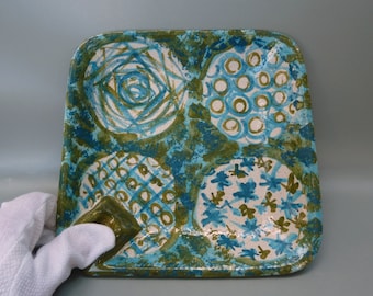 May include: Square ceramic tray with a blue and green abstract design. The tray has four sections, each with a different pattern. The tray is perfect for serving snacks or appetizers.