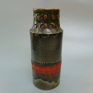 May include: A dark green ceramic vase with a red band and a row of orange circles around the top.