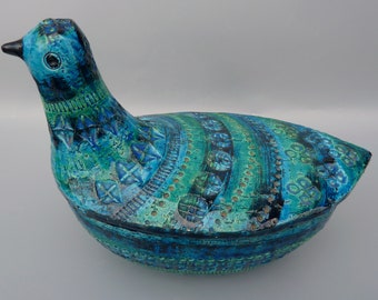 May include: A blue and green ceramic bird-shaped dish with intricate patterns. The dish has a lid and is decorated with a variety of geometric and floral designs.