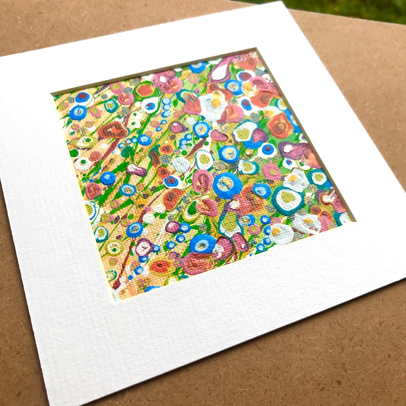 May include: Abstract painting with a white background and a variety of colors, including blue, green, yellow, pink, and orange. The painting features a swirling pattern of circles and dots.