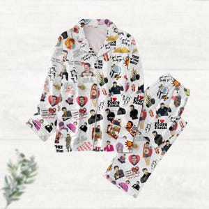 May include: White pajama set with a repeating pattern of images and text. The long-sleeved top and pants feature various illustrations, including portraits, hearts, and phrases like "I love Pedro Pascal" and "This is the way."