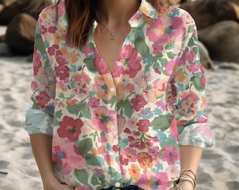 May include: A button-down shirt with a vibrant floral pattern in shades of pink, red, orange, and blue. The long-sleeved shirt has a collared neckline and is made of a lightweight fabric. The shirt is paired with blue jeans.