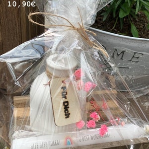Wooden plate with candle, vase and decoration