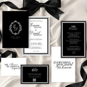 May include: Elegant black and white wedding invitation suite. Includes invitation cards, RSVP cards, and detail cards. Features a black bow and ribbon on a white satin background. The invitations display names, dates, and event details.