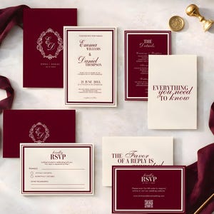 May include: A collection of burgundy and cream wedding stationery. Includes invitations, RSVP cards, and detail cards. Some cards feature the names "Emma & Daniel" and the text "Everything you need to know". A gold wax seal and ribbon are also present.