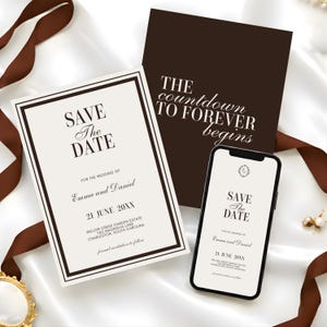 May include: A wedding invitation suite with a Save the Date card, a card with the text "The countdown to forever begins," and a smartphone displaying a digital Save the Date. The cards are cream-coloured with dark brown borders and text. Brown ribbon accents the scene.