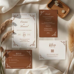 May include: A wedding stationery set featuring a main invitation, a details card, and two RSVP cards. The cards are printed in white and terracotta brown with ornate corner flourishes and elegant serif typography. The text includes names Emma and Daniel.