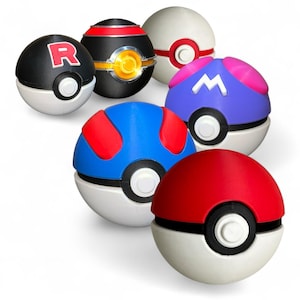 May include: A collection of six colorful Poké Ball replicas. The balls feature various designs, including red, blue, black, and white, with accents of red, yellow, and purple. Each ball has a white base and a black center ring.