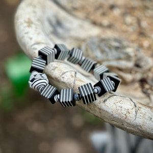 Whether you're a fan of Beetlejuice, an admirer of Art Deco aesthetics, or simply someone who appreciates unique and handcrafted jewelry, this bracelet is sure to make a statement wherever you go.