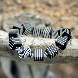 Whether you're a fan of Beetlejuice, an admirer of Art Deco aesthetics, or simply someone who appreciates unique and handcrafted jewelry, this bracelet is sure to make a statement wherever you go.