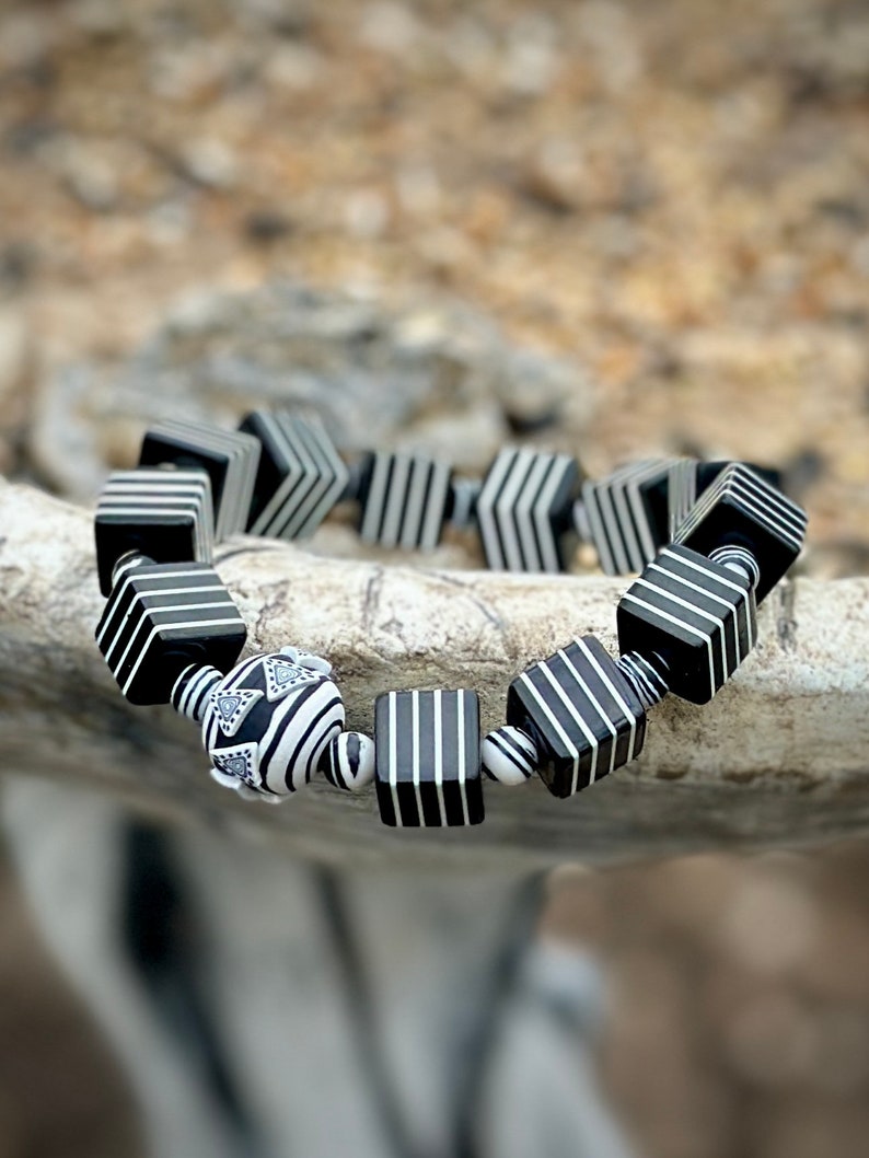 Whether you're a fan of Beetlejuice, an admirer of Art Deco aesthetics, or simply someone who appreciates unique and handcrafted jewelry, this bracelet is sure to make a statement wherever you go.