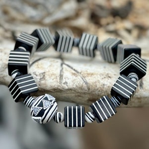 Whether you're a fan of Beetlejuice, an admirer of Art Deco aesthetics, or simply someone who appreciates unique and handcrafted jewelry, this bracelet is sure to make a statement wherever you go.