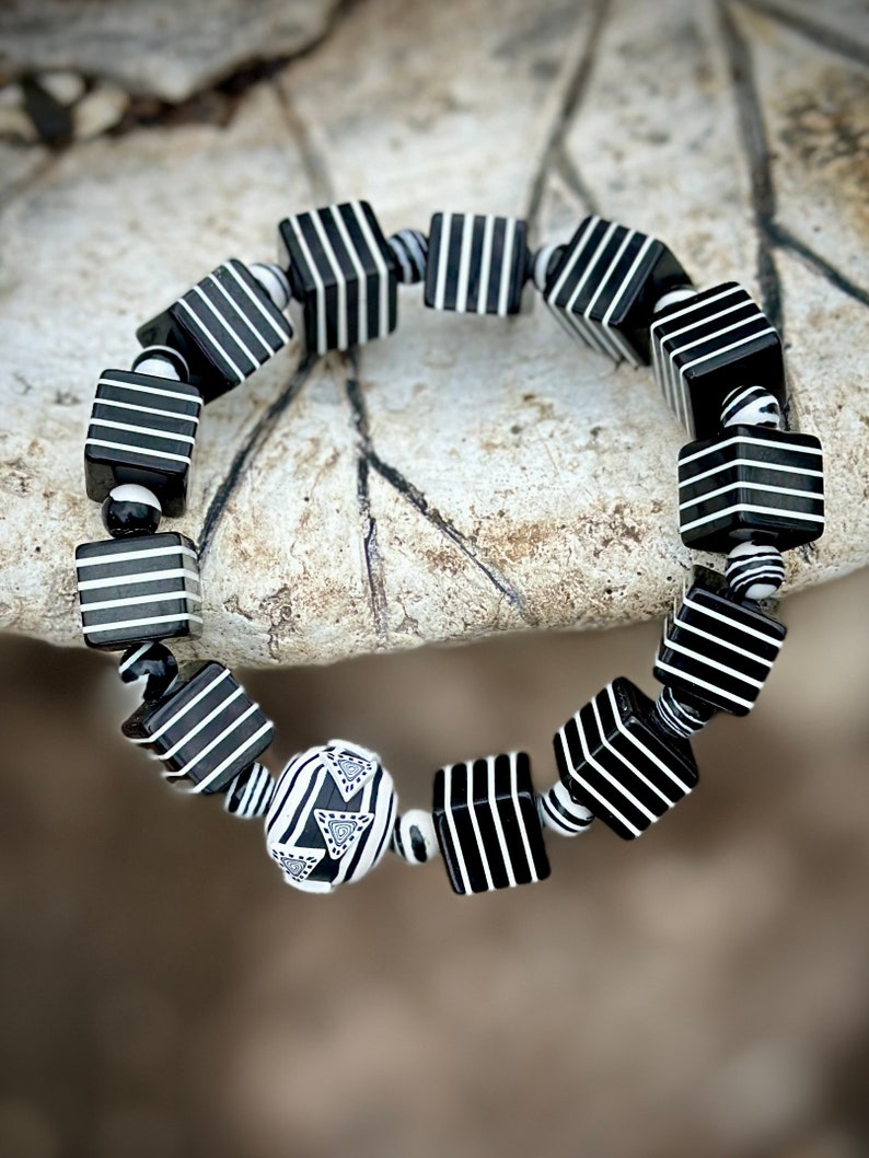 Whether you're a fan of Beetlejuice, an admirer of Art Deco aesthetics, or simply someone who appreciates unique and handcrafted jewelry, this bracelet is sure to make a statement wherever you go.