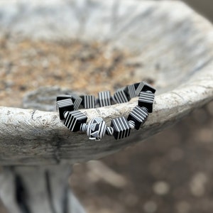 Whether you're a fan of Beetlejuice, an admirer of Art Deco aesthetics, or simply someone who appreciates unique and handcrafted jewelry, this bracelet is sure to make a statement wherever you go.