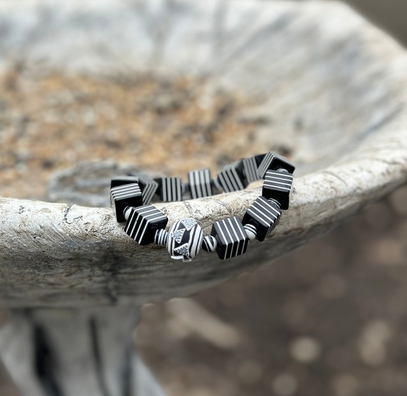 Whether you're a fan of Beetlejuice, an admirer of Art Deco aesthetics, or simply someone who appreciates unique and handcrafted jewelry, this bracelet is sure to make a statement wherever you go.