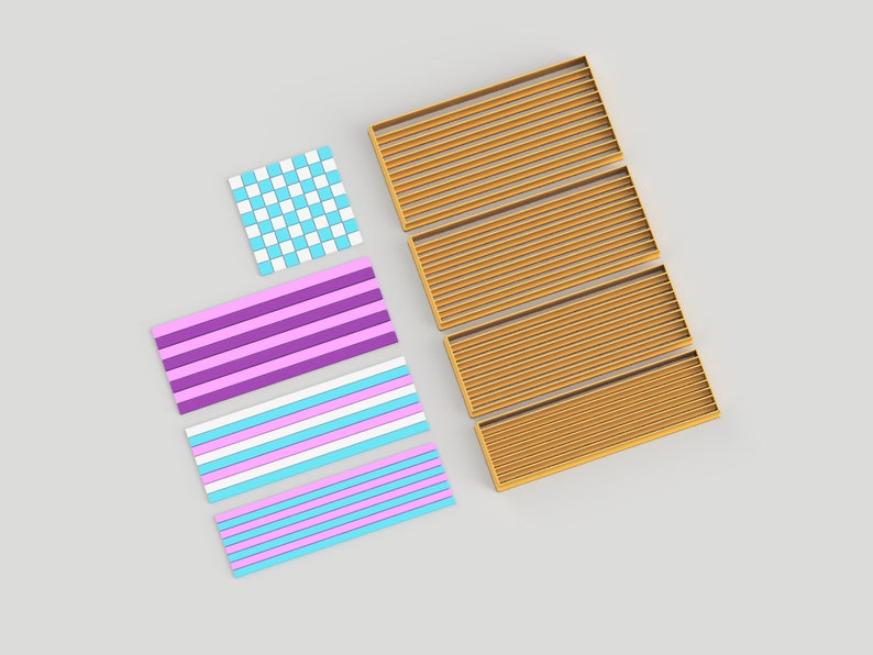 May include: Four gold-colored cookie cutters in the shape of a rectangle with horizontal lines. There are also three cookie cutters in the shape of a rectangle with different colored stripes. One cookie cutter is a checkered pattern in blue and white.